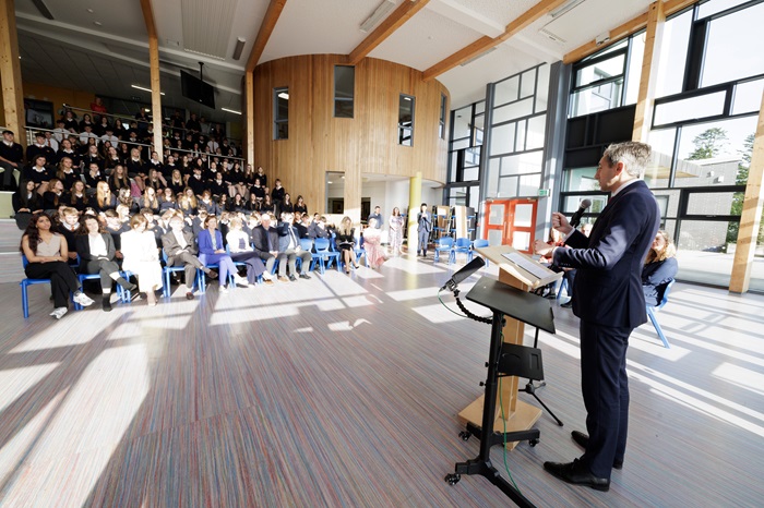 Man talking wih large group of pupils